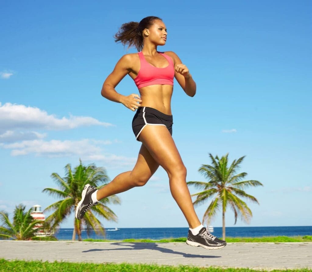 A healthy fit young woman, running on a beach
