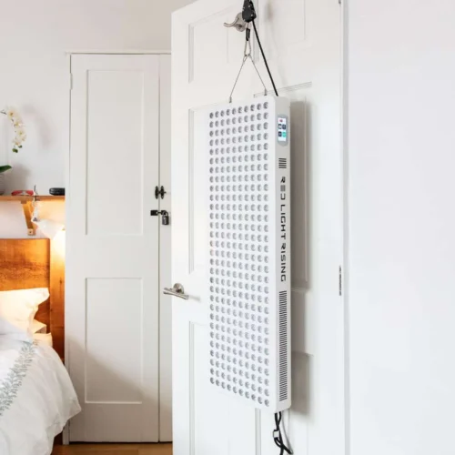 Red Light Therapy Panel hanging on a door